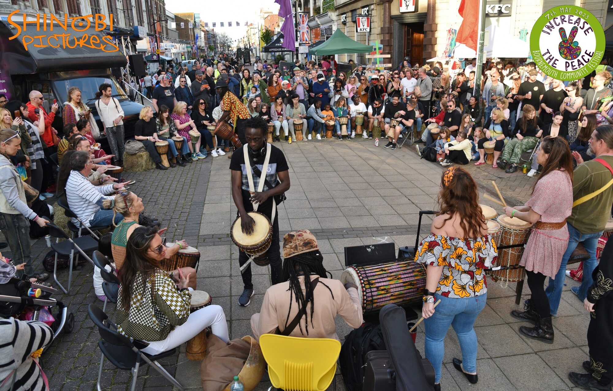Increase the Peace — a drum circle drawing a crowd on the high street