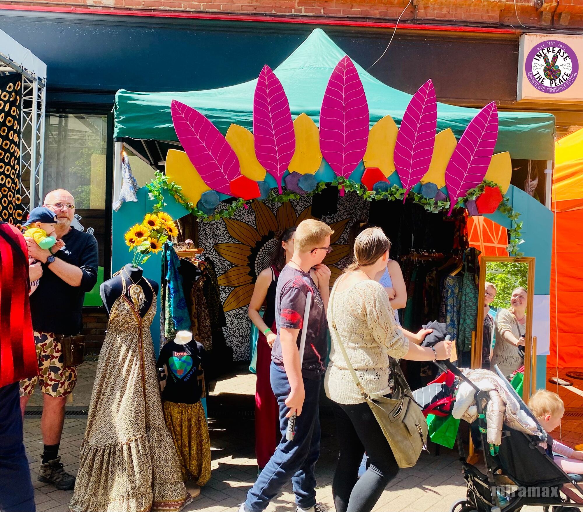 Increase the Peace — a decorated market stall in the sun